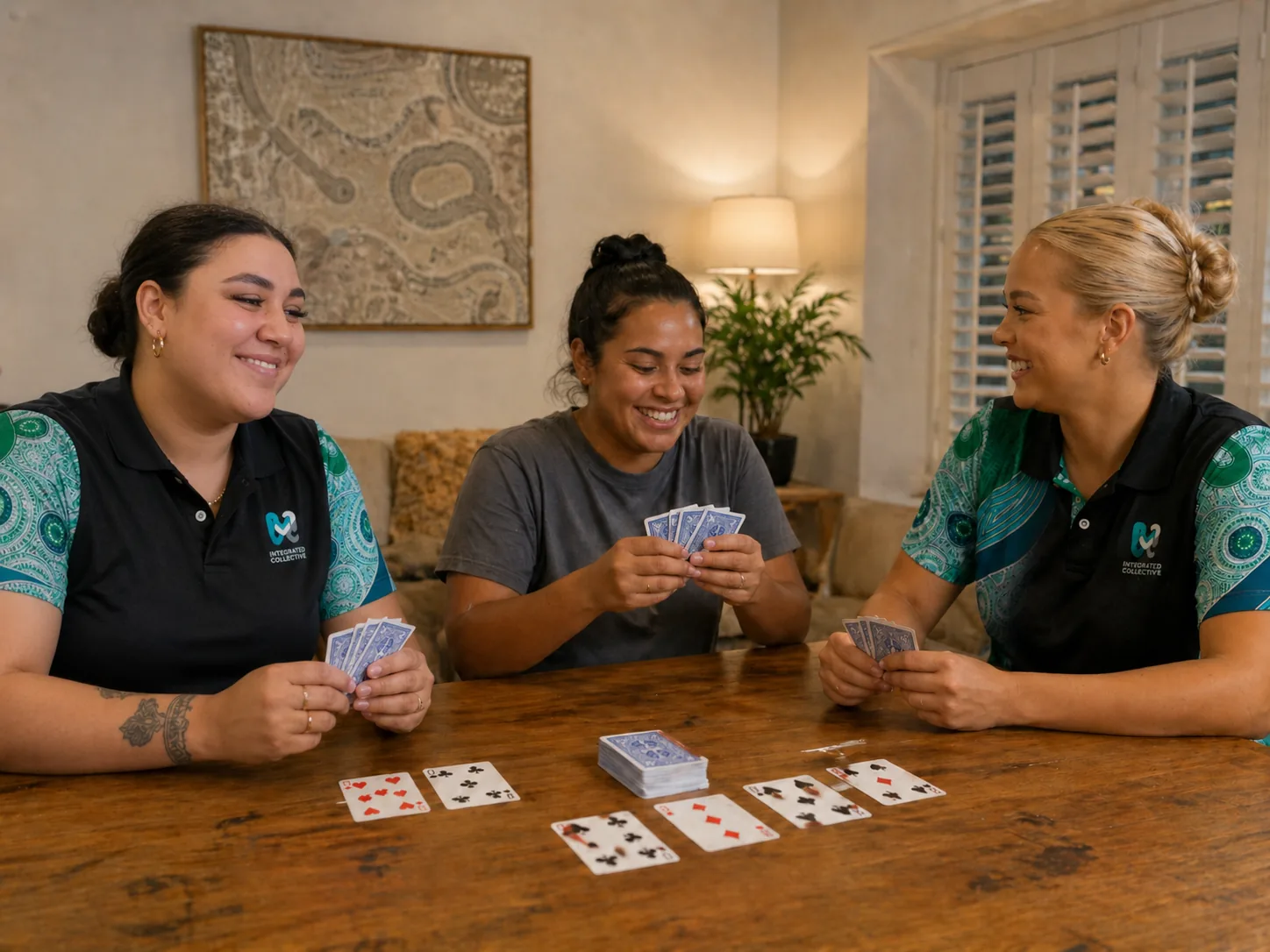 Integrated Collective team members sharing a card game around a table